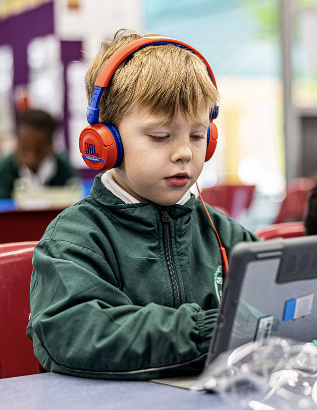 Student with headphones at Good Shepherd Catholic Primary Plumpton