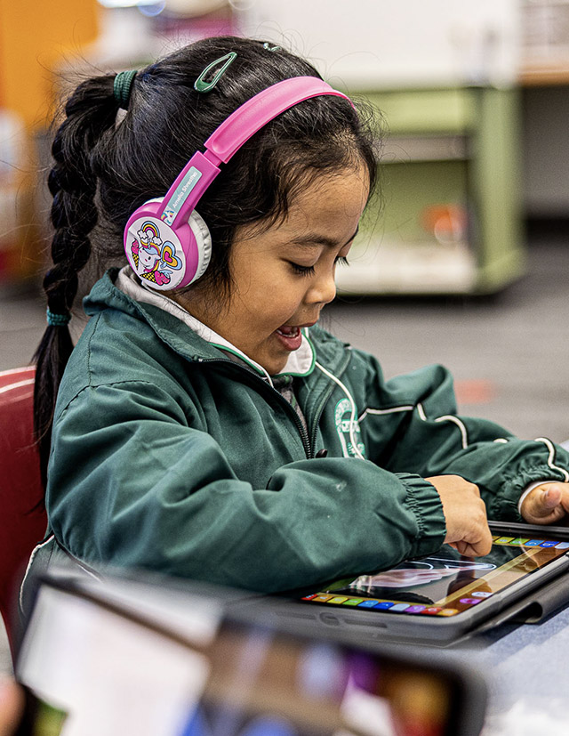 Girl with headphones at Good Shepherd Catholic Primary Plumpton